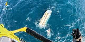 Three men were winched from an overturned boat.