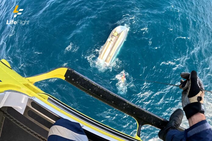Three men were winched from an overturned boat.