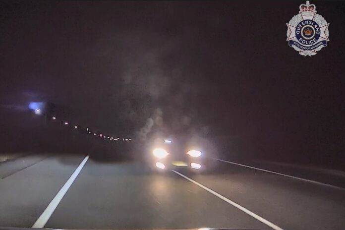 Footage shows a vehicle driving on the wrong side of the road and almost into the path of police. Picture: QPS.