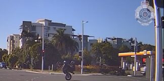 A motorbike rider was filmed on one wheel, by police dashcam.