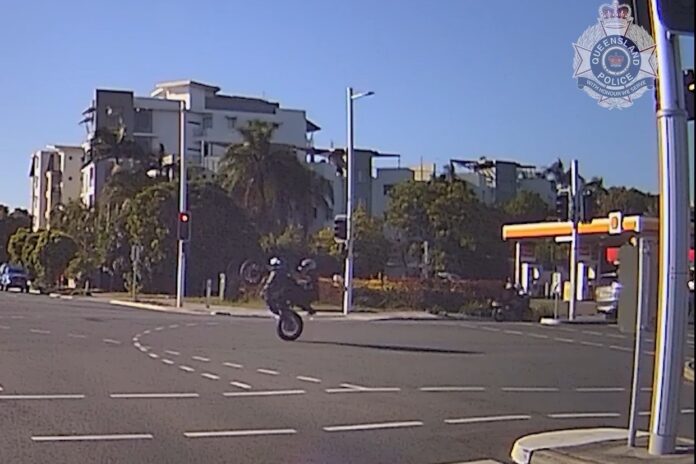 A motorbike rider was filmed on one wheel, by police dashcam.