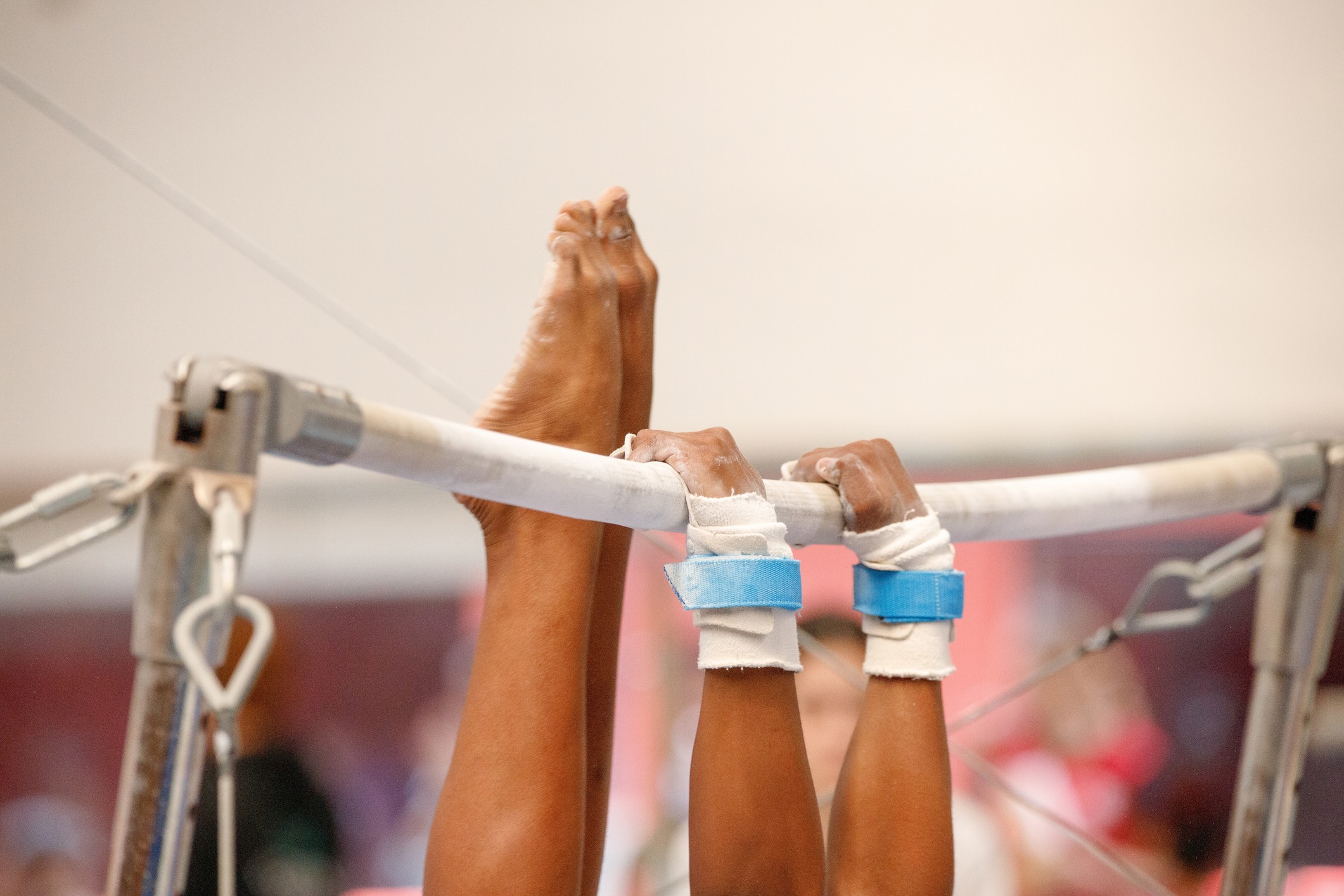 A gymnast on a high bar.