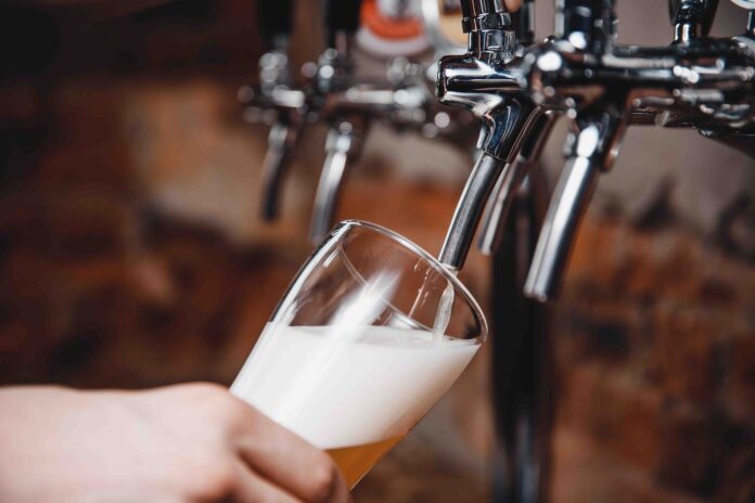 Ashley Robinson still finds pleasure in small, everyday things like beer despite economic uncertainty.