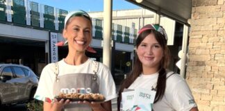 Staff members with some of the offerings at the new Motto Motto store.