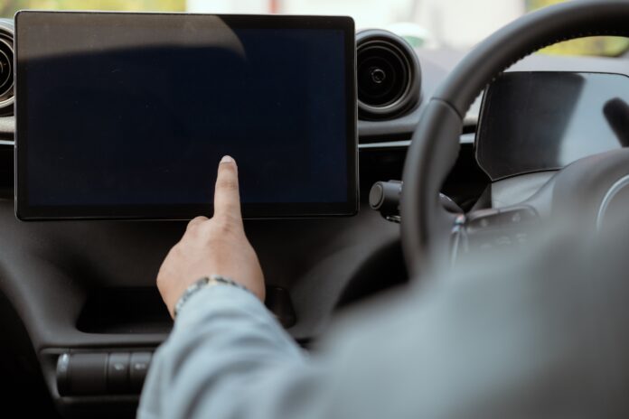 A driver using a touchscreen.