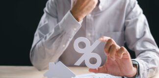 Picture illustrating an individual assessing how the 2026 federal budget changes to capital gains tax and negative gearing will impact him