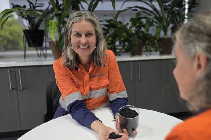 Unitywater CEO Anna Jackson holding a sample of the type of biochar the proposed Unitywater facility would produce.