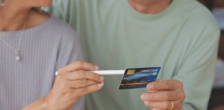 Man and woman holding a credit card. Shutterstock.