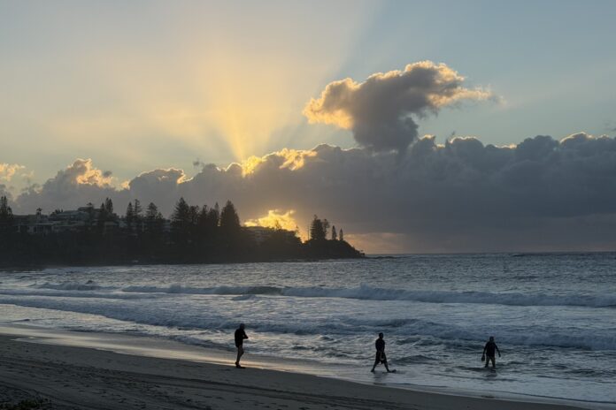 Photo of the day by photographer Lesley Evans of three early morning swimmers at Kings Beach