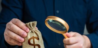 man holding money bag. shutterstock