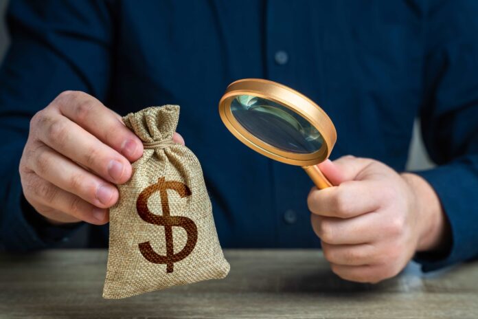 man holding money bag. shutterstock