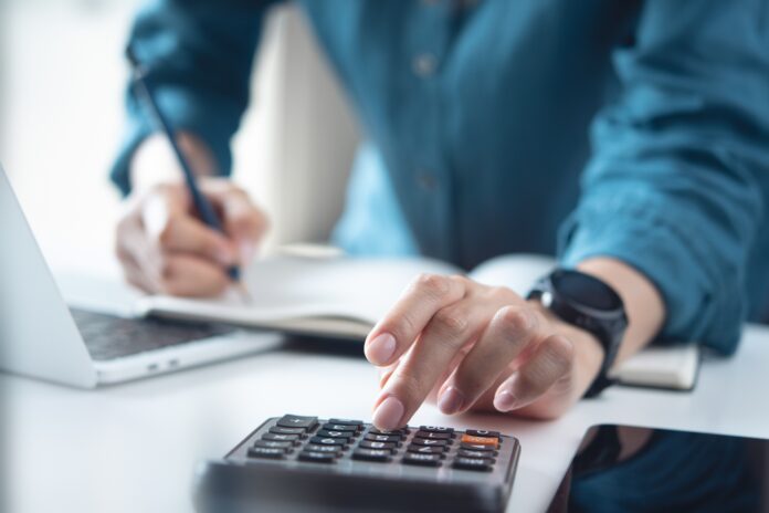 man using calculator. shutterstock