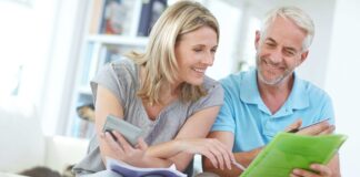 Photo from shutterstock of middle aged couple reviewing their finances