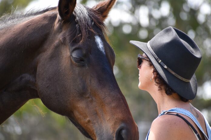 A woman connects with a horse during a session at Hoofbeats Sanctuary. Picture: Supplied