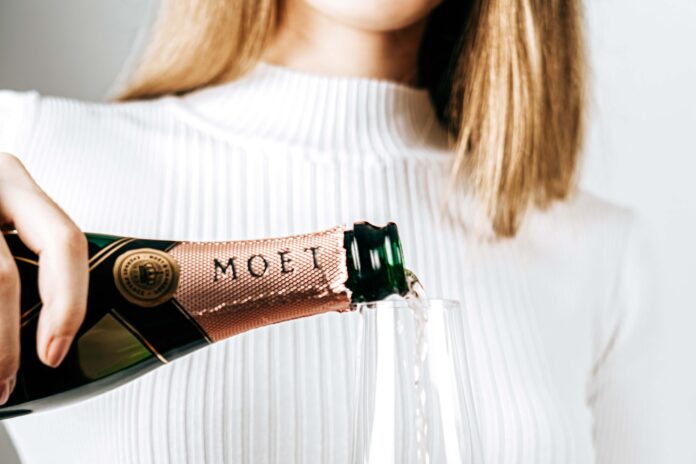 woman pouring Moet champagne. Picture: shutterstock