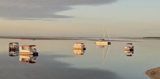 Boats anchored off Golden Beach by photographer Peter Collins.