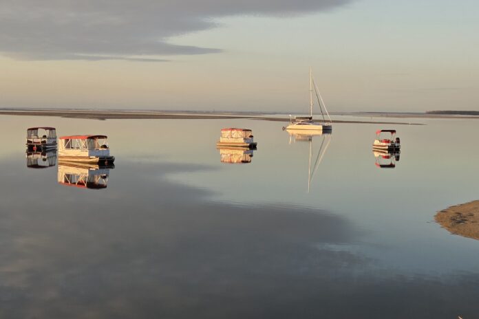 Boats anchored off Golden Beach by photographer Peter Collins.