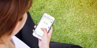 Woman doing Goggle search on her phone shutterstock