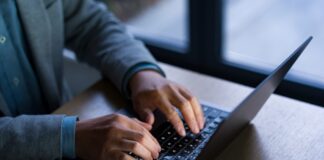 An unidentified man working on a laptop.