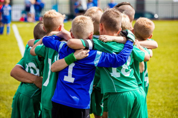 Boys in a huddle at a soccer game.