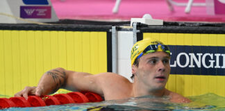 Isaac Cooper in the pool at the end of a race at Glasgow 2026.