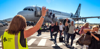 Passengers walk across the tarmac at Sunshine Coast Airport.