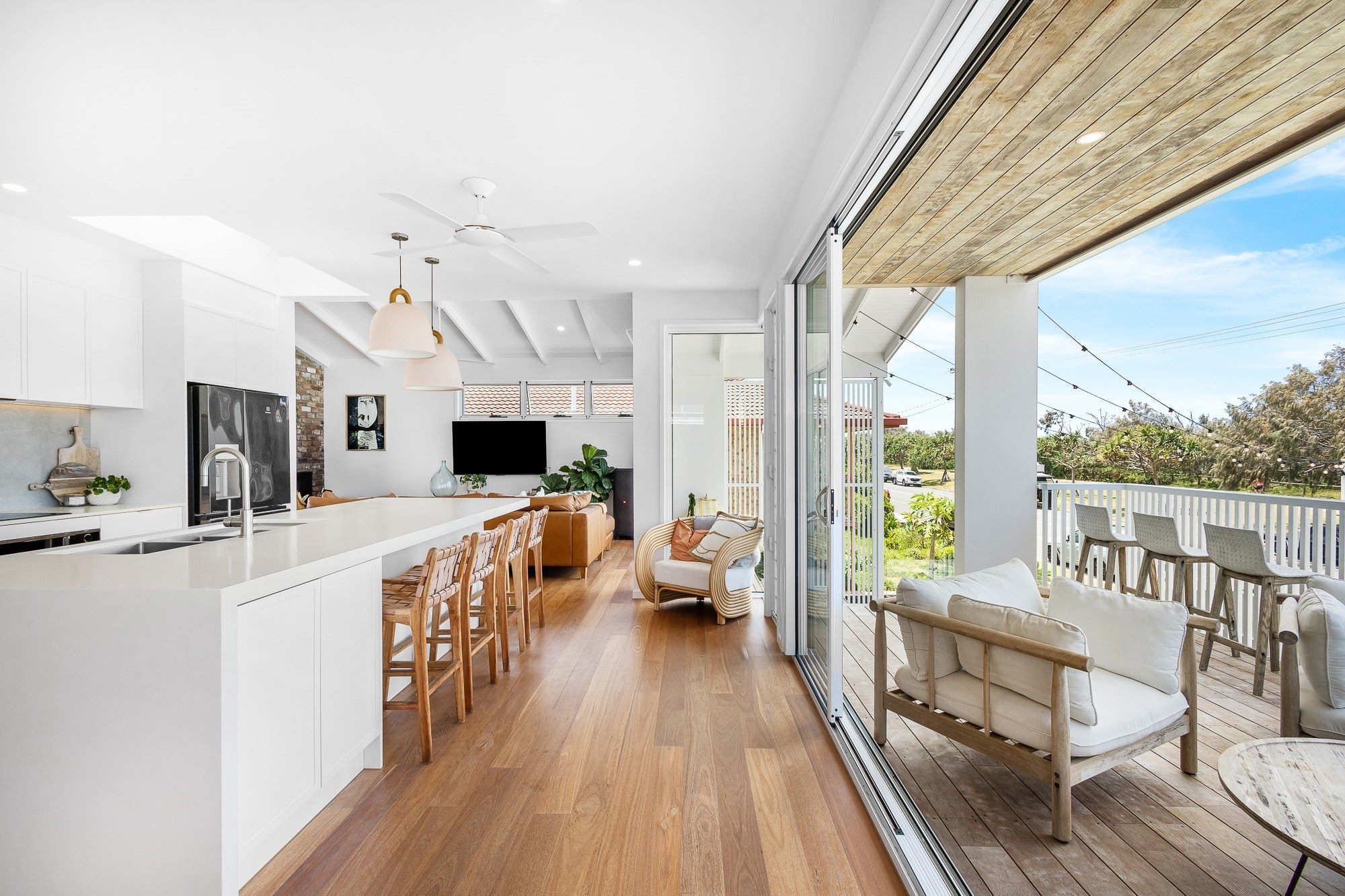 Kitchen flowing onto outdoor deck at 122 Pacific Boulevard Buddina.