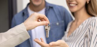A couple being handed house keys.