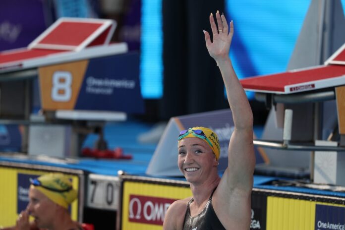 Lani Pallister waves to the crowd from the pool at the Pan-Pacs.