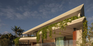 The exterior of Azura at Mooloolaba shows glass windows and a roof overhaghing a pool