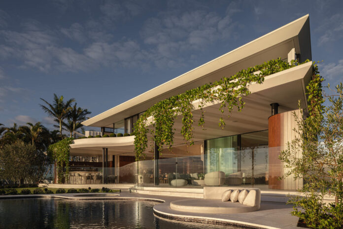 The exterior of Azura at Mooloolaba shows glass windows and a roof overhaghing a pool