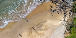 Paralympic logo in sand at Coolum Beach