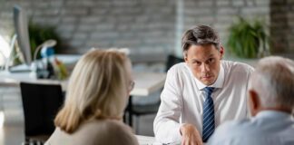 Man dispensing advice to clients shutterstock