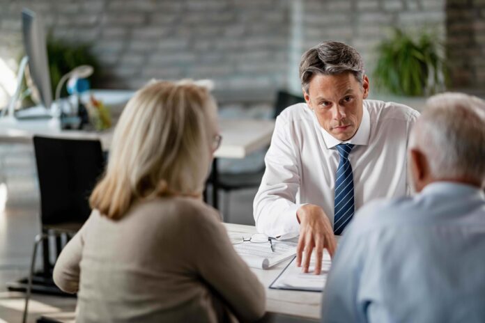 Man dispensing advice to clients shutterstock