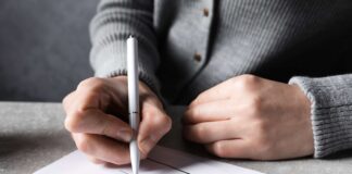 man signing a Will shutterstock