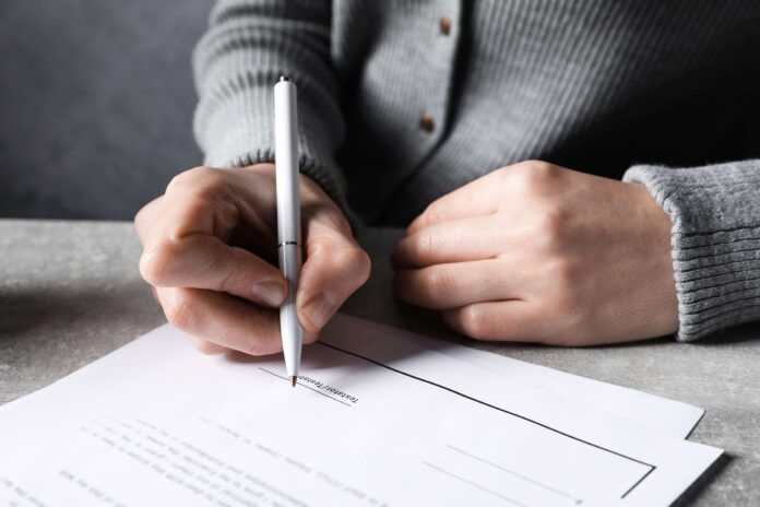 man signing a Will shutterstock