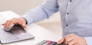 man with calculator shutterstock