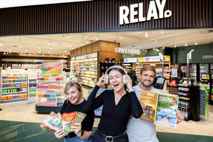 Three people in front of the Relay store.