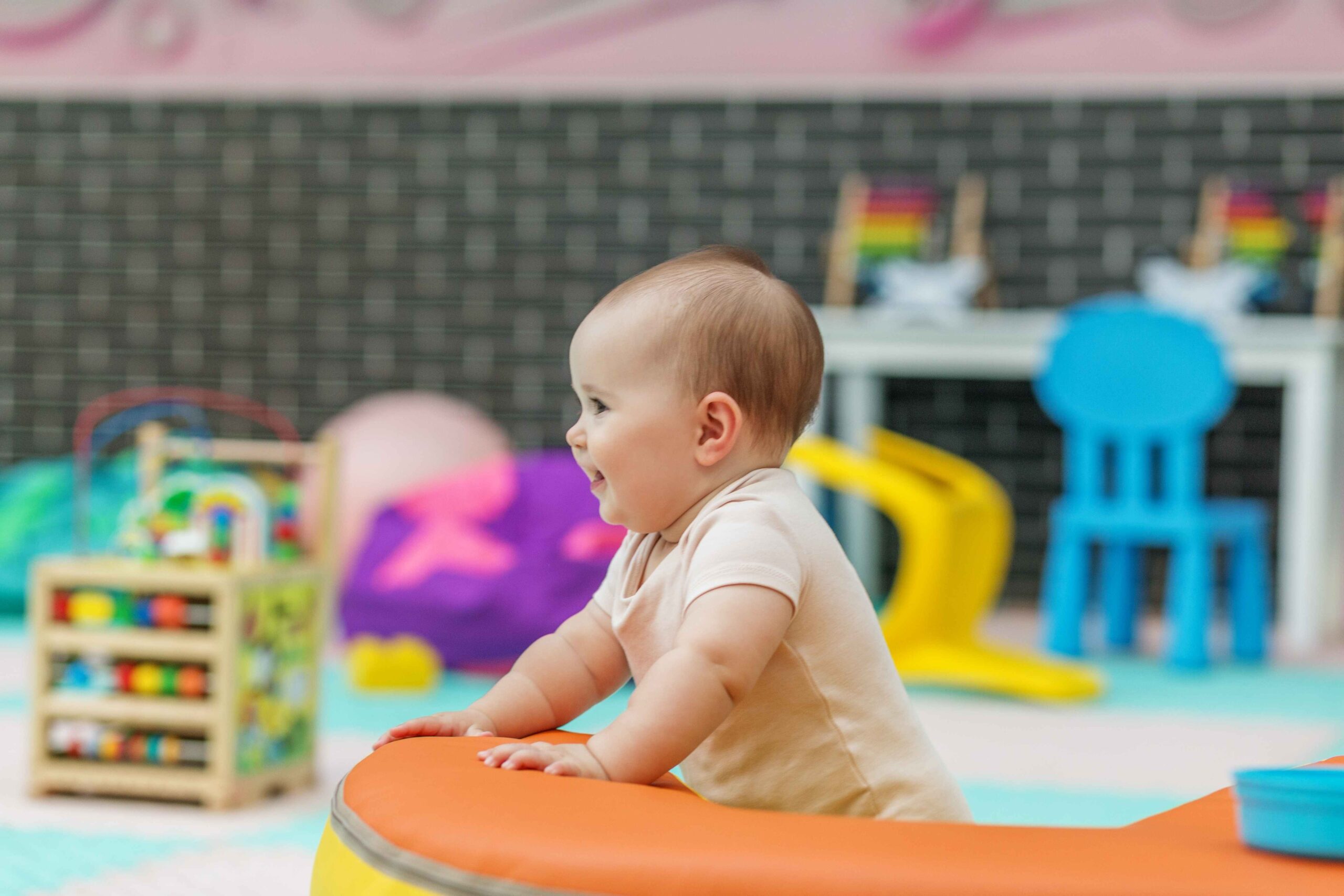 A baby smiling at a day care centre
