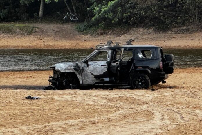 A burnt out car on the beach