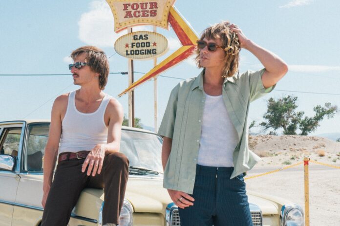 Louis and Oli Leimbach in front of a car.