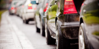 A close up of vehicles in traffic.