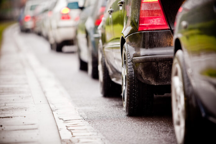 A close up of vehicles in traffic.