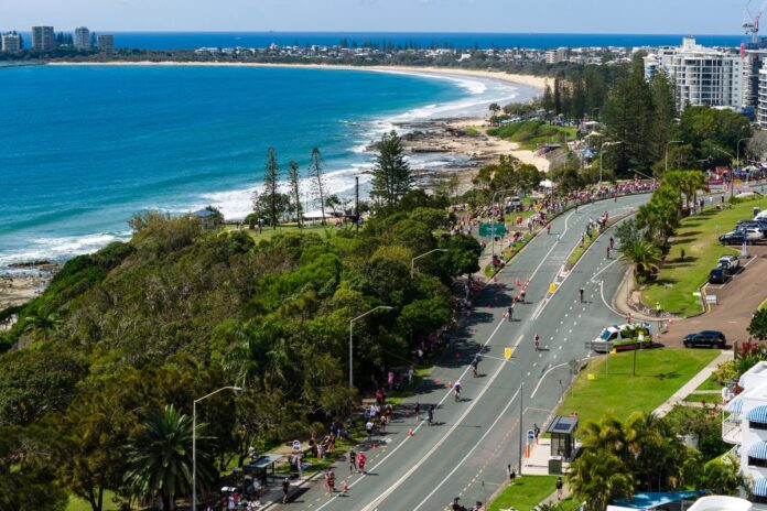 An aerial photo of competitors on a coastal road for IRONMAN 70.3 Sunshine Coast.