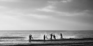 Swimmers at sunrise at Alexandra Headland black and white photo.