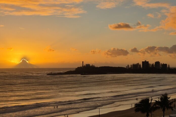 sun peeking out from cloud at dawn at Mooloolaba
