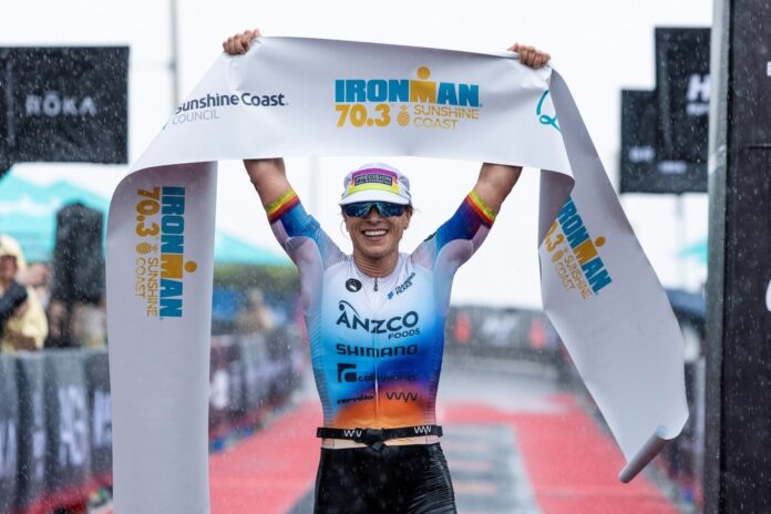 Hannah Berry holds the winning banner above her at the finish line.