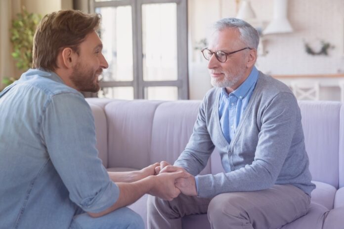 young man talking to his father from Shutterstock