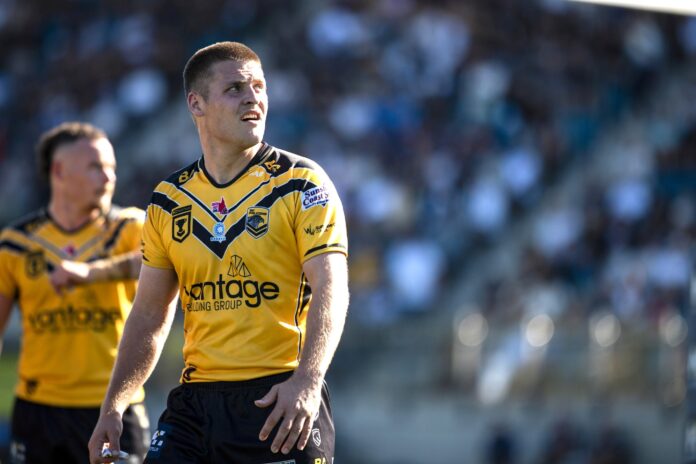 Sunshine Coast Falcons halfback Josh Lynn takes a breath on the field.
