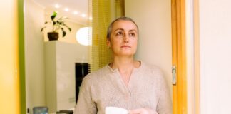 Unimpressed middle aged woman with cuppa shutterstock